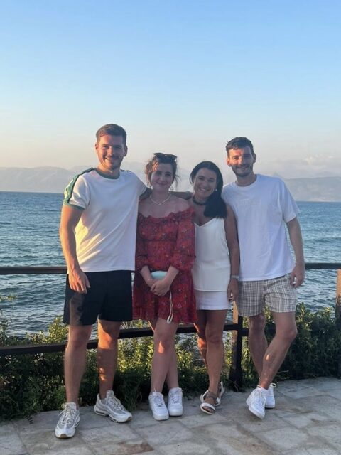 Group of Tourists stand next to the ocean