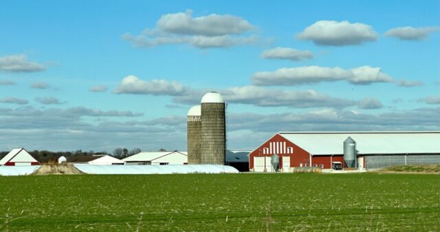 Kansas farm with grain towers seen from the highway on Florida to Colorado EV roadtrip
