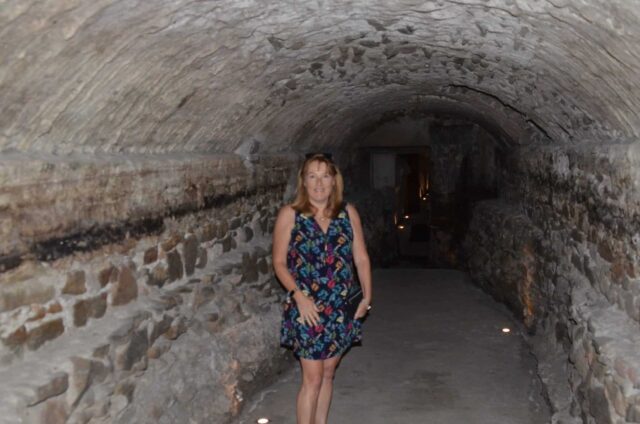 Woman walking through an underground tunnel in Puebla Mexico which were originally for soldiers moving from outside the city.