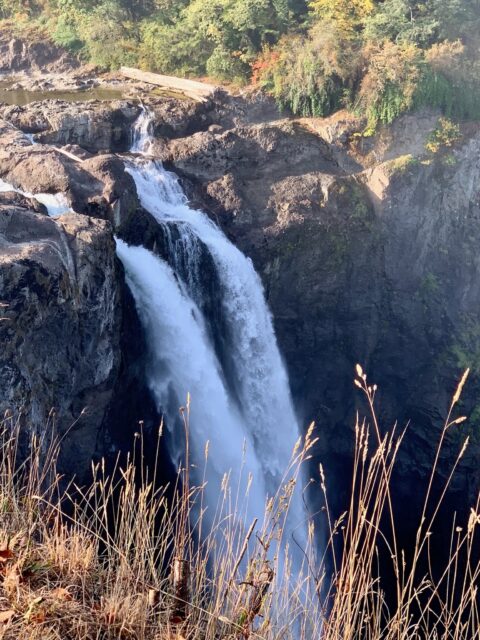 Two cascades of water rushing down a cliff edge