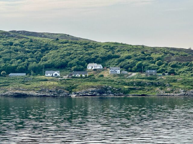 Whitewashed cottages at the shore of Colonsay Scotland