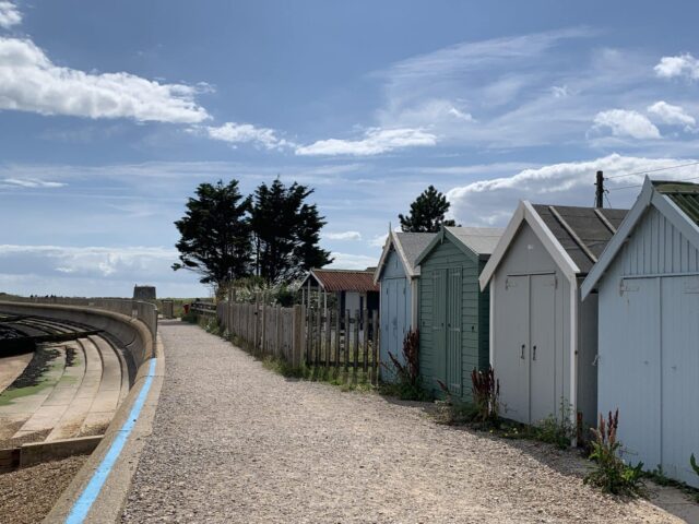 Beach huts and a pathway to the water.
