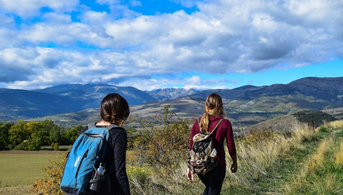 Two woman hiking in mountains.