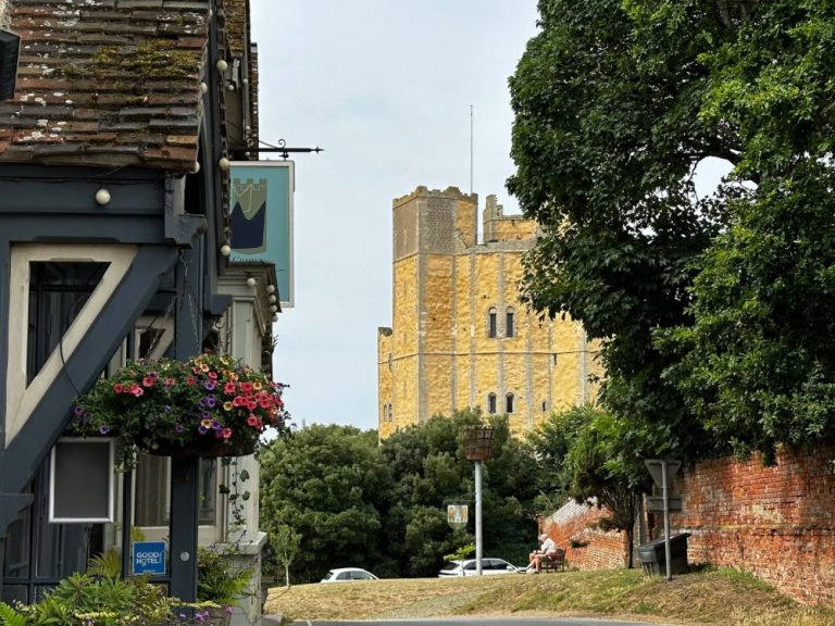View of a brick castle and side street pub in Orford Suffolk.