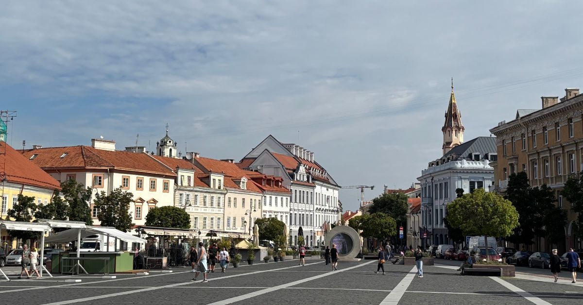 View from Town Hall Steps with buildings, market stall and a church spire