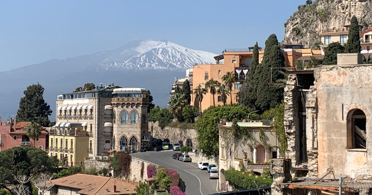 Italian main road with Mount Etna in the background and building in the foreground